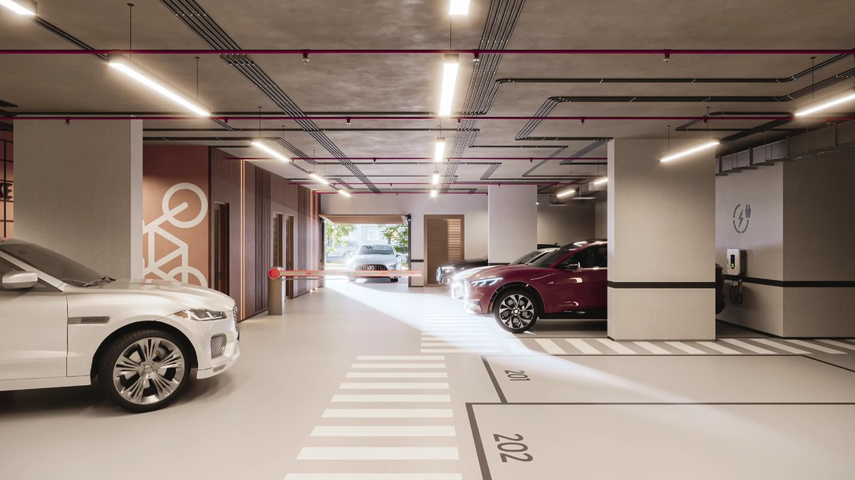 Garagem com iluminação linear, vagas demarcadas e carregador elétrico